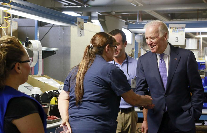 Vice President Joe Biden, right, greets worker Pamela Mesolella, left, during a visit at the Bobrick Washroom Equipment Factory in Los Angeles on Wednesday, July 22, 2015. (AP Photo/Nick Ut)